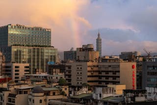 A rainbow is seen over the city of Taipei during sunset